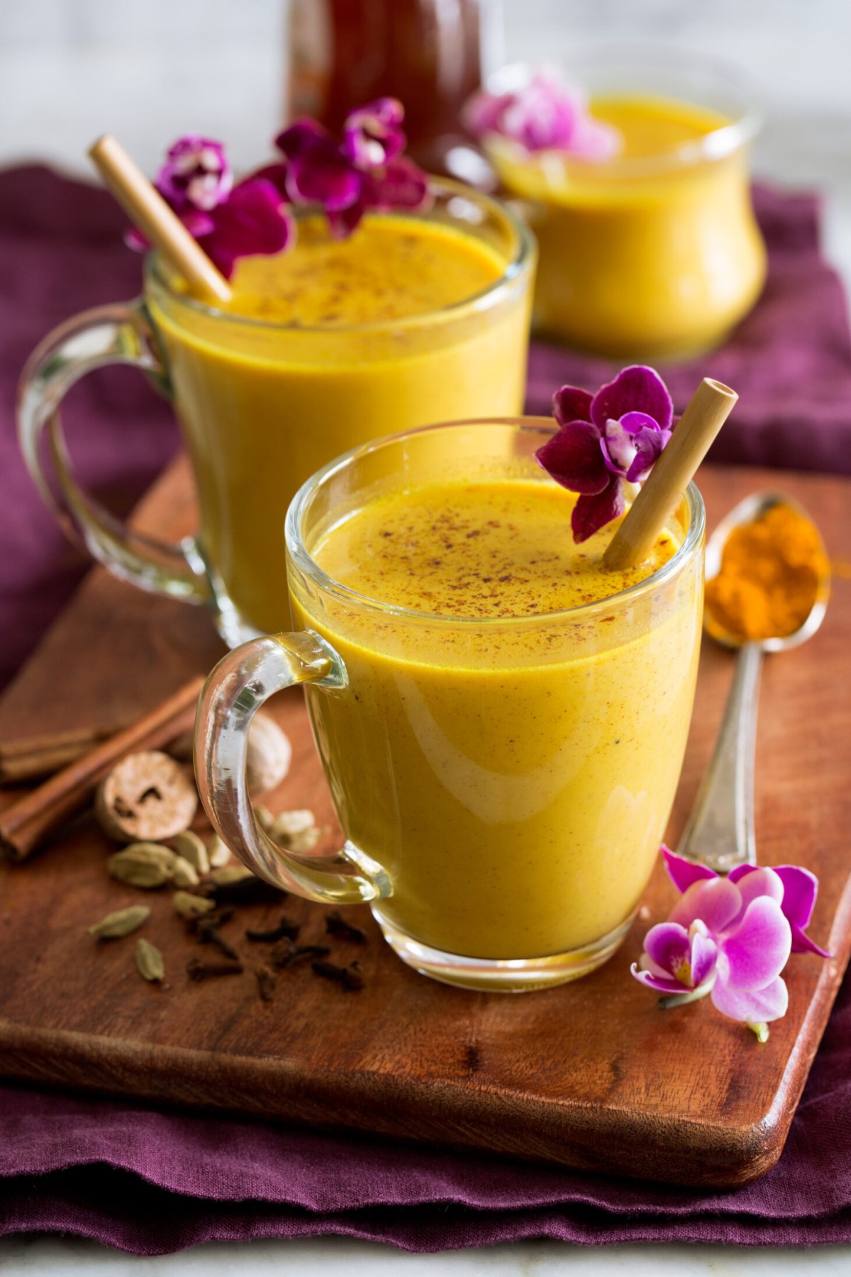 A mug of warm golden turmeric milk near a window in the morning.