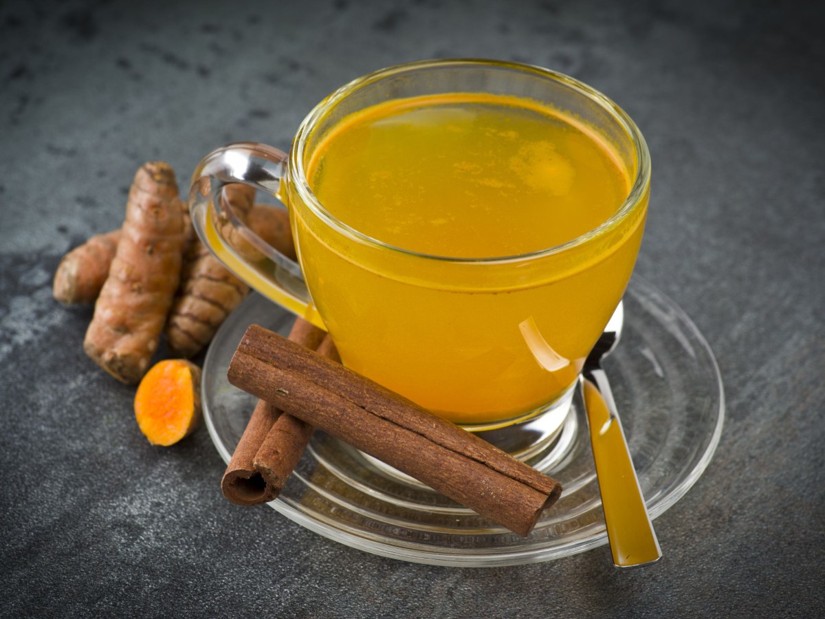 Turmeric powder, ginger, lemon, black pepper and honey arranged on a kitchen board ready to make a weight loss drink