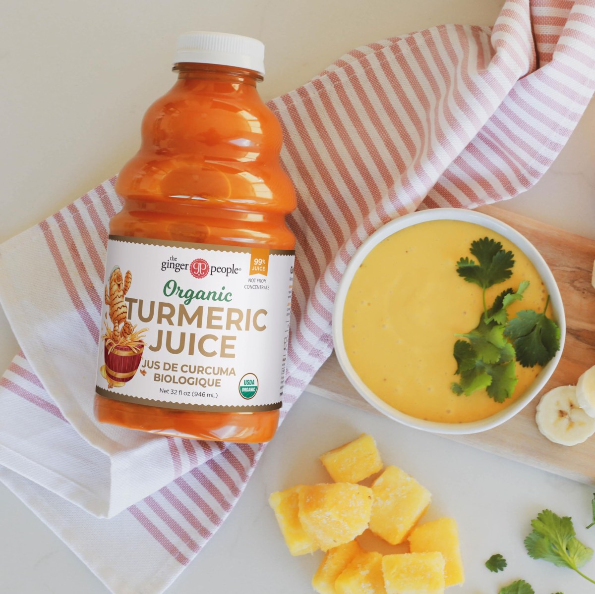 A reusable water bottle filled with turmeric, lemon, and ginger infused water