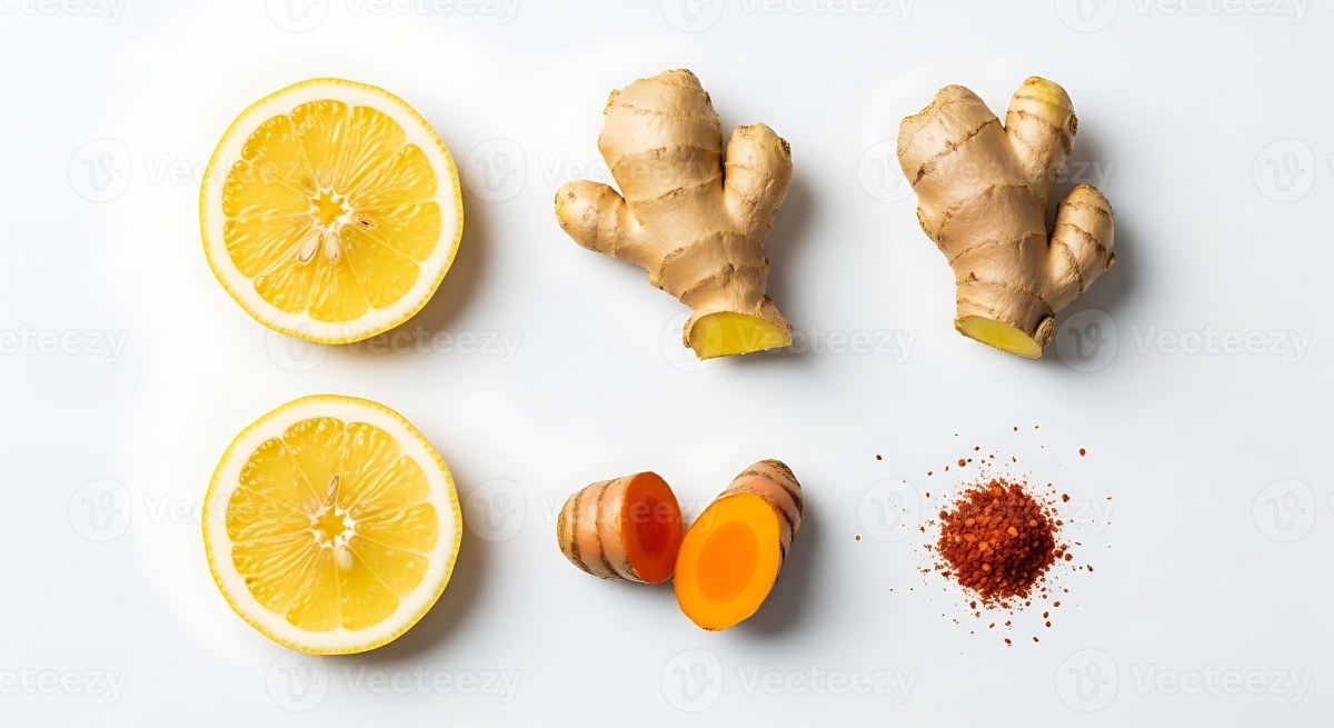Turmeric powder, ginger, lemon, black pepper and honey arranged on a table