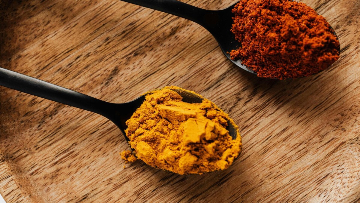 Person preparing turmeric in a cozy kitchen as part of a daily routine