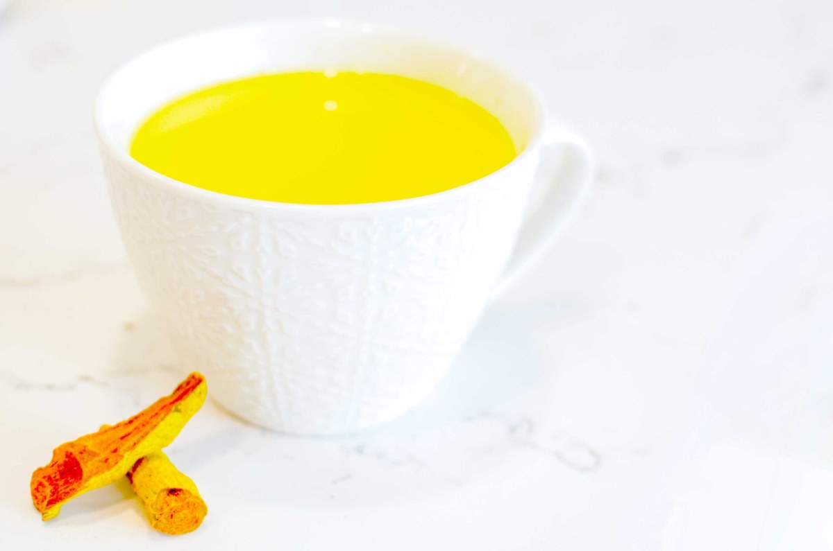 A homemade turmeric latte in a cozy living room setting